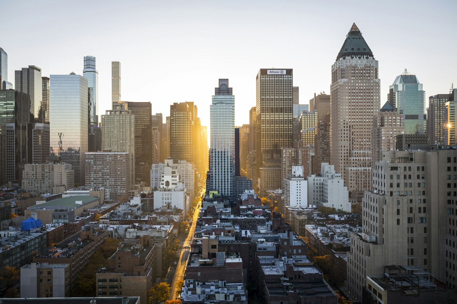 Sunrise pouring down the avenue between city towers