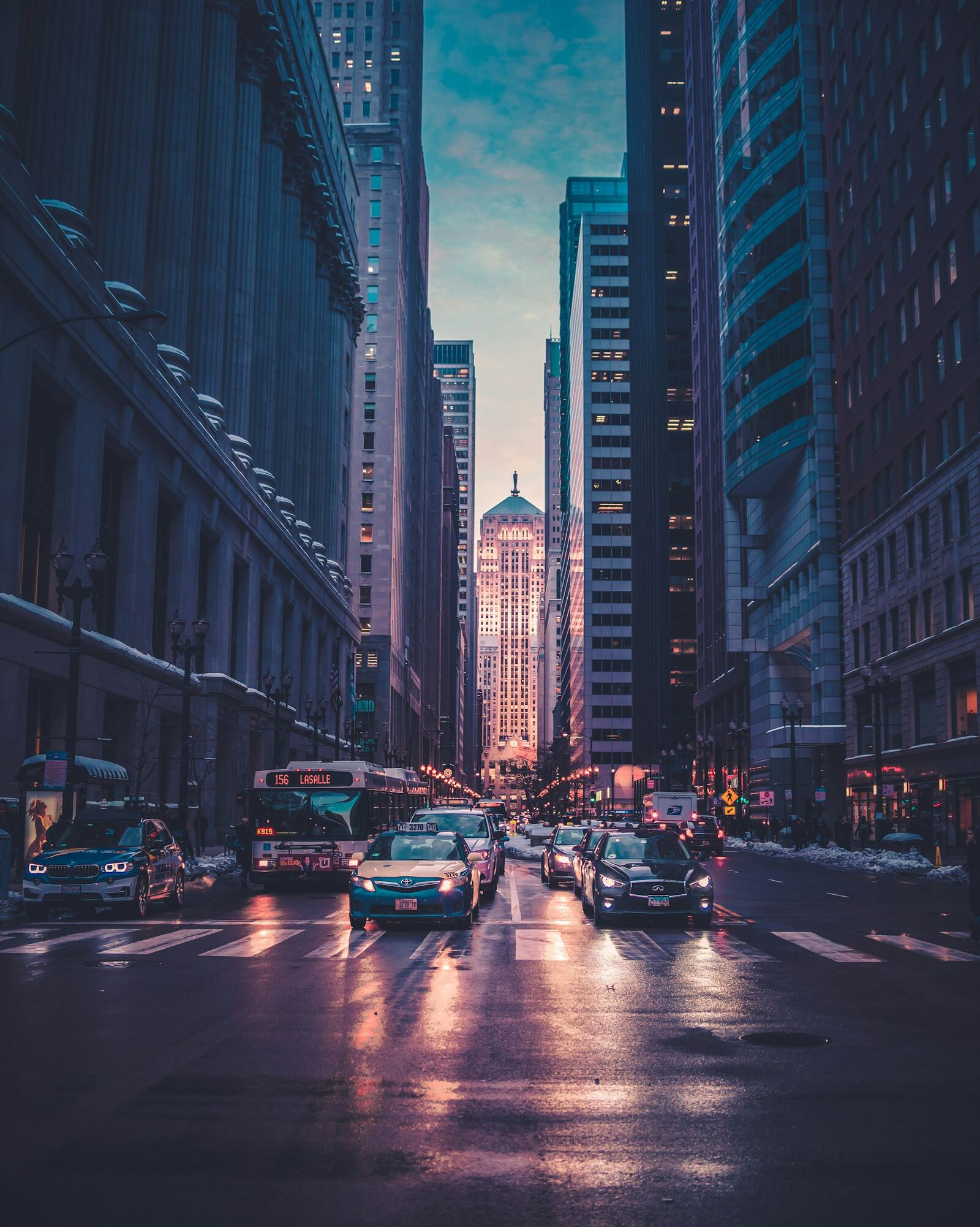 A rain-slick city street at night glowing with neon signs